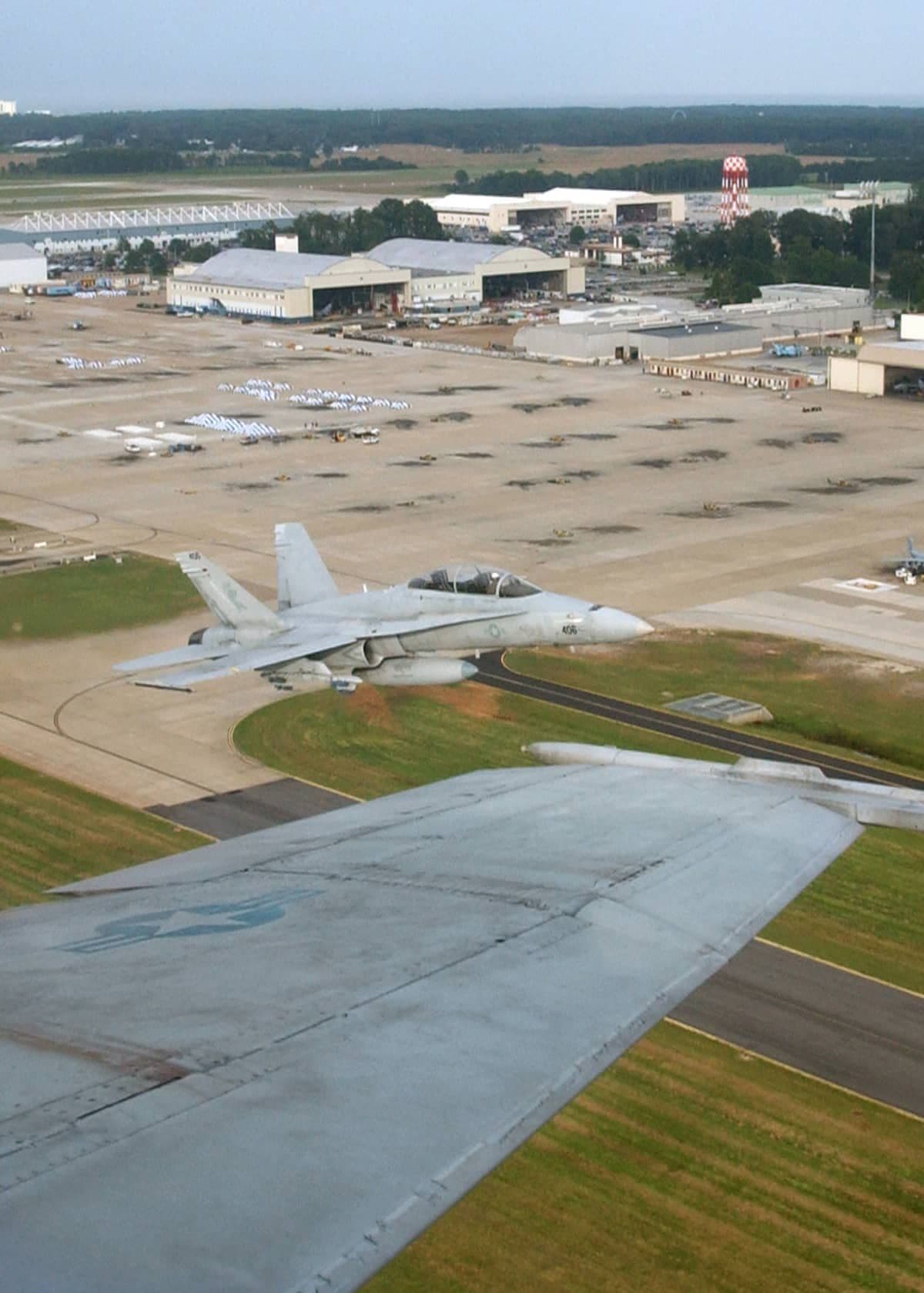 Two VFA-106 F/A-18 Hornets in section takeoff above NAS Oceana.