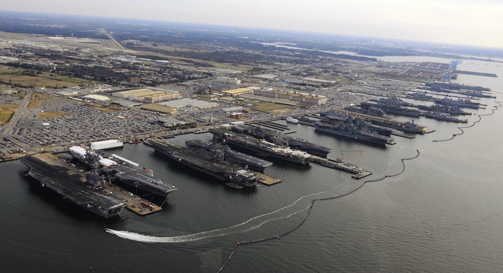 Nine U.S. Navy aircraft carriers and other warships moored at piers at Naval Station Norfolk in December 2012.